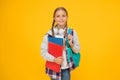 Hello school. Happy girl ready for school on yellow background. Little kid hold books and school bag. Small child back Royalty Free Stock Photo