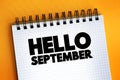 Hello September text quote on notepad, concept background