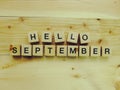 Hello september wooden block alphabet letters on wooden background