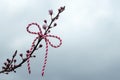 Hello spring background, March first holiday concept. Martenitsa on blossoming cherry tree branch. copy space Royalty Free Stock Photo