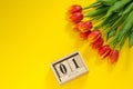 Hello, spring! Beggining of spring. Bright woman flat lay of red tulip flowers and wooden calendar with date of 1 march. Copy Royalty Free Stock Photo