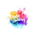 Hello spring - handwritten modern calligraphy inspirational text on multicolored watercolor paint splash. Background with abstract