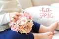 Hello Spring message with toddler boy with flowers