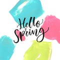 Hello Spring. Modern calligraphy text at colorful background with blue, pink and green acrylic paint strokes.