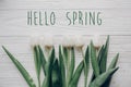 Hello spring text fresh sign.flat lay. stylish white tulips on r