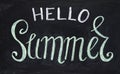 Hello Summer inscription by chalk on blackboard. Hello Summer handdrawn illustration. Summer lettering. Royalty Free Stock Photo