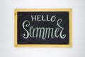 Hello Summer inscription by chalk on blackboard top view photo. Hello Summer handdrawn illustration on chalkboard.