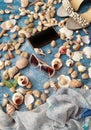 Seashell on blue background ,ocean marine   Summer sea holiday   sunglass phone  white sandals pearl beach nature background Royalty Free Stock Photo