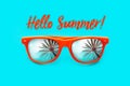 Hello Summer text Orange sunglasses with palm tree reflections isolated in intense cyan background. Minimal image concept. Royalty Free Stock Photo