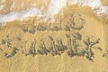 Hello Summer Text Written by Hand on Beach Sand Washed Away by Foamy Sea Wave. Top View. Inspirational Lifestyle Image Royalty Free Stock Photo