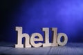 Hello, text words typography written on wooden block against blue background, life and business motivational inspirational