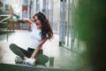 Hello there. Beautiful woman with curly black hair have good time in the city at daytime Royalty Free Stock Photo