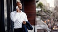 Hello to new opportunities. a handsome young businessman talking on a cellphone outside his office. Royalty Free Stock Photo