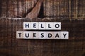 Hello Tuesday alphabet letters on wooden background