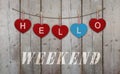 Hello weekend written on hanging red and blue wooden hearts