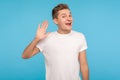 Hello, welcome! Portrait of funny happy hospitable man in casual white t-shirt waving hand