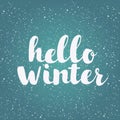 Hello winter text. Brush lettering at blue winter background with snowflakes and bokeh lights. Vector card design with Royalty Free Stock Photo