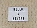 HELLO WINTER word on lightbox on knit background. Cozy compozition. Knit background. Royalty Free Stock Photo