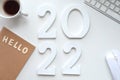 Wooden number 2022, keyboard and coffee cup on the table.Hello 2022 Royalty Free Stock Photo