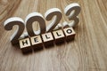 Hello 2023 word alphabet letters on wooden background