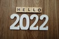 Hello 2022 word alphabet letters on wooden background Royalty Free Stock Photo