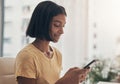 Hello world, its nice to know youre still here. a young woman using a smartphone while working from home.