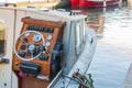 Helm of a boat, vintage wooden navigation panel with steering wheel