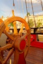 Helm wheel of an old wooden sailboat. Details of the deck of the ship Royalty Free Stock Photo