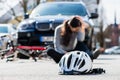 Helmet on the asphalt after accidental collision between bicycle and car