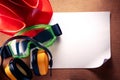 Helmet, earphones, goggles and blank paper Royalty Free Stock Photo