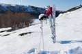 Helmet and Goggles with Skis and Poles on Hillside