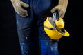 Helmet held by a construction worker. Protective clothing for ma Royalty Free Stock Photo
