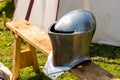 Helmet iron shining medieval warrior defense army forged rivets on the background of a marching tent