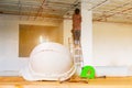 helmet plastic white with glasses, paper roll plan blueprint and measuring tape green on wood table