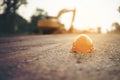 Helmet at road construction site and machinery worker background