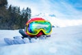 Helmet with ski mask and gloves in snow mountain range on back Royalty Free Stock Photo