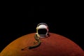 helmet from spacesuit lying on mars planet