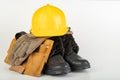 Helmet, work boots and gloves on a white table. Workwear for the production worker Royalty Free Stock Photo