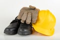 Helmet, work boots and gloves on a white table. Workwear for the production worker Royalty Free Stock Photo