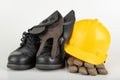 Helmet, work boots and gloves on a white table. Workwear for the production worker Royalty Free Stock Photo