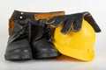 Helmet, work boots and gloves on a white table. Workwear for the production worker Royalty Free Stock Photo