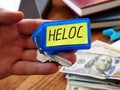 Heloc loan concept. Hand holds key as symbol of property buying Royalty Free Stock Photo