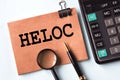 HELOC - words on a brown sheet on the background of a calculator Royalty Free Stock Photo