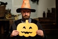 Helowin scenery for the holiday. Man holding a carved pumpkin. Party on October 31. Scary background. Happy halloween Royalty Free Stock Photo