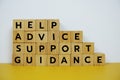 Help, Advice, Support, Guidance with wooden blocks alphabet letterstop view on wooden background Royalty Free Stock Photo