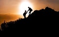 Help and assistance concept. Silhouettes of two people climbing on mountain and helping. Generative AI Royalty Free Stock Photo