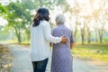 Help and care Asian senior or elderly old lady woman use walker with strong health while walking at park in happy holiday. Royalty Free Stock Photo