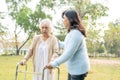 Help and care Asian senior or elderly old lady woman use walker with strong health while walking at park in holiday Royalty Free Stock Photo