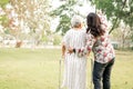 Help and care Asian senior or elderly old lady woman use walker with strong health while walking at park. Royalty Free Stock Photo