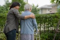 Help and care Asian senior or elderly old lady woman use walker with strong health while walking at park in happy fresh holiday Royalty Free Stock Photo